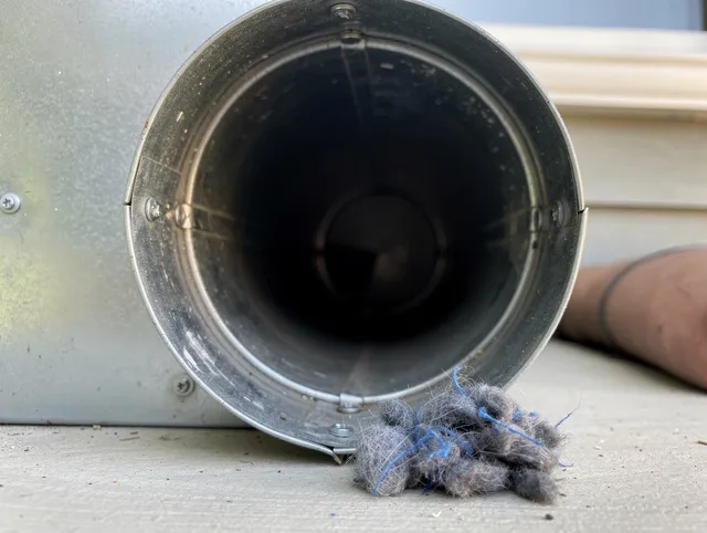 Branford Dryer Vent Cleaning technician using specialized equipment to clear severe dryer vent blockage in Branford